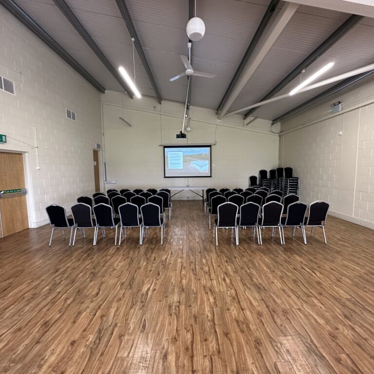 community hall setup with chairs facing projector
